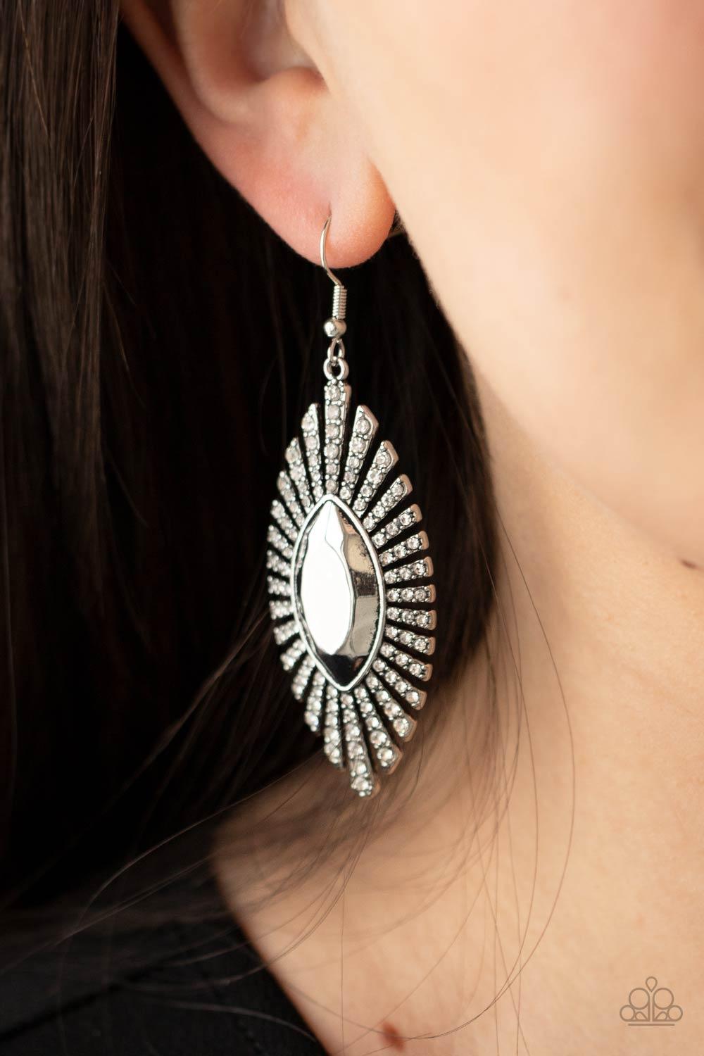 Paparazzi Accessories Who Is The Fiercest Of Them All - White Dotted in dainty white rhinestones, flared rectangular frames fan out from an oversized marquise shaped center, creating a dramatic effect. Earring attaches to a standard fishhook fitting. Sold