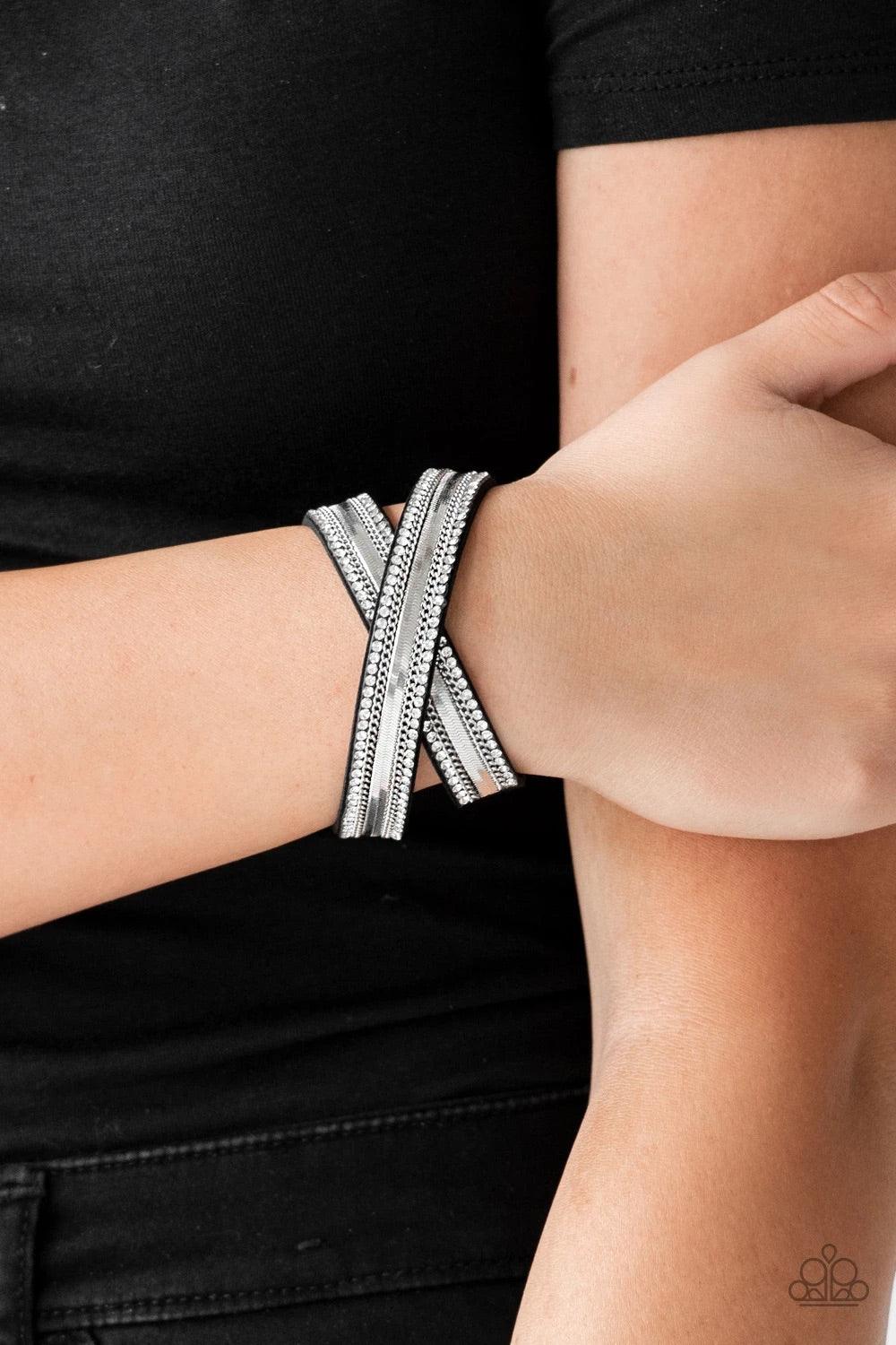 Paparazzi Accessories Rocker Rivalry - Black Rows of classic silver chain, flat silver chain, and dainty white rhinestones are encrusted along a black suede band for a sassy look. The elongated band allows for a trendy double wrap design. Features an adju
