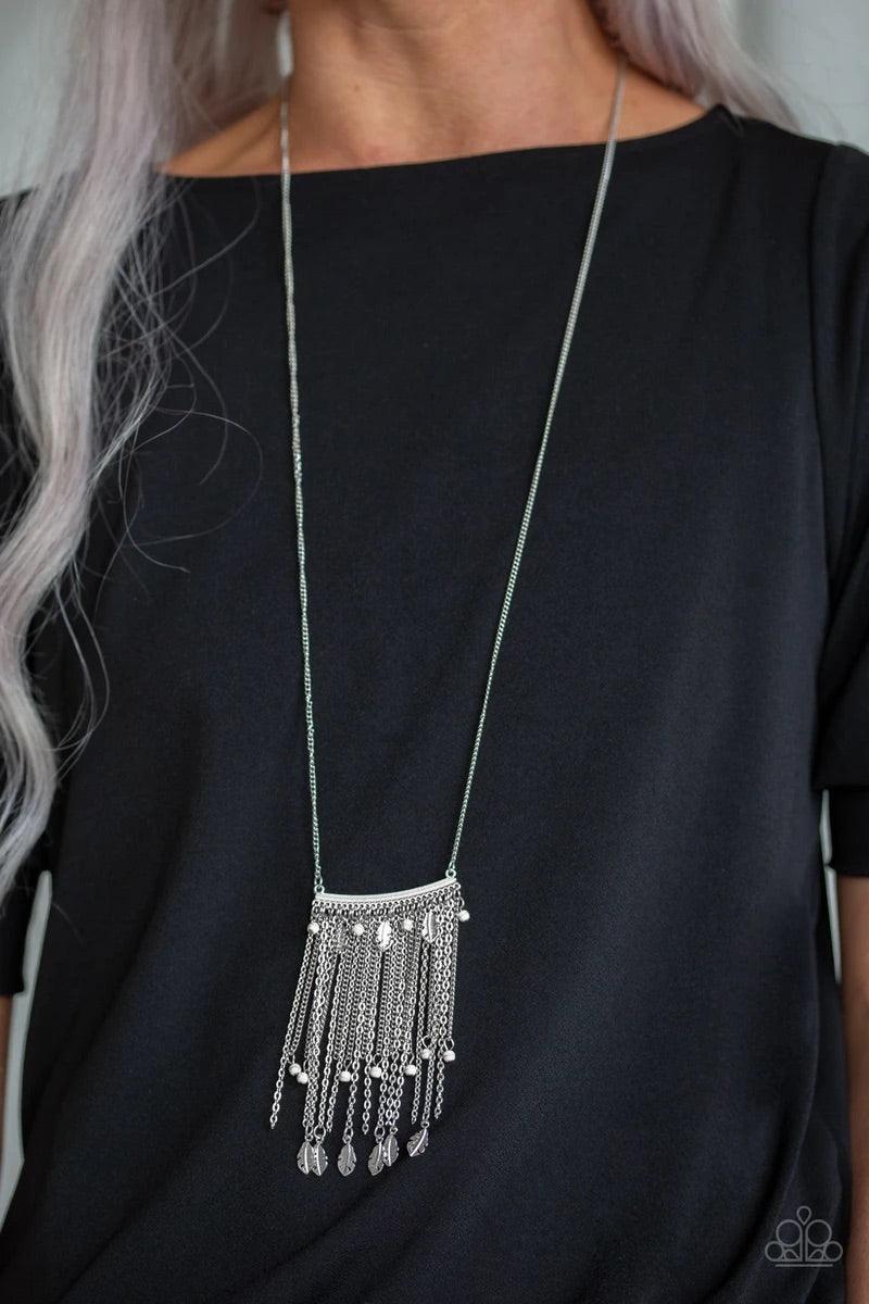Paparazzi Accessories On The Fly - White Attached to a lengthened silver chain, a hammered silver bar gives way to a fringe of shimmery silver chain, white stone beads, and silver feather frames for a seasonal look. Features an adjustable clasp closure. S