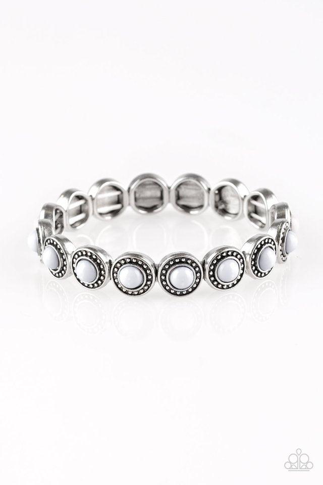 Paparazzi Accessories Globetrotter Goals - Silver Dotted with neutral gray beaded centers, studded silver frames are threaded along stretchy elastic bands and linked around the wrist for a whimsical look. Sold as one individual bracelet. Jewelry