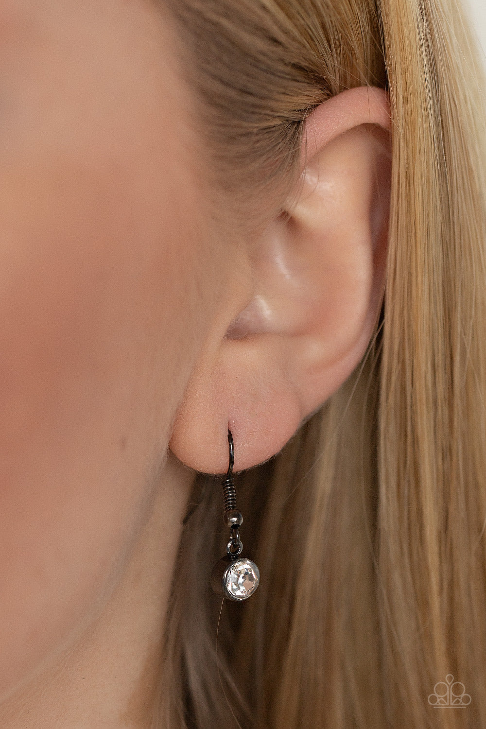 Paparazzi Accessories Token of My Gratitude - Black An icy row of glittering white rhinestones is pressed into the center of a hammered gunmetal disc, splitting the oversized pendant seemingly in two as it swings from the bottom of an extended gunmetal ch