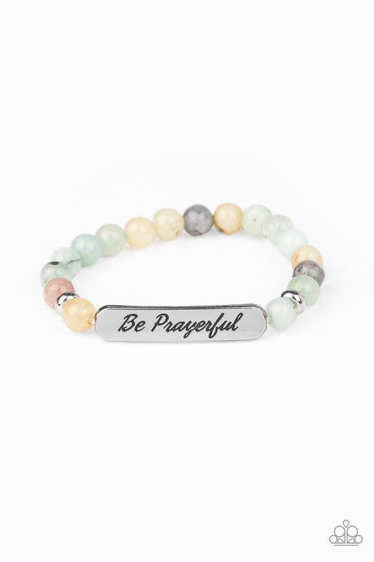 Paparazzi Accessories Be Prayerful - Green Infused with dainty silver accents, a collection of glassy stone beads and a shimmery silver frame stamped in the phrase, "Be Prayerful", are threaded along a stretchy band around the wrist for an inspirational l