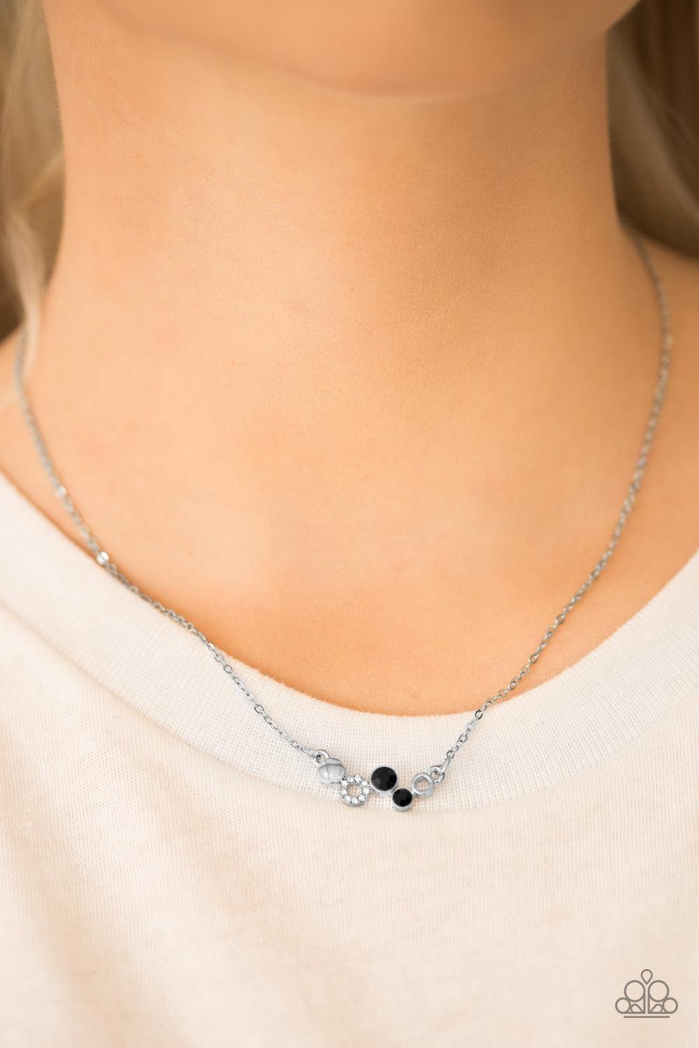 Paparazzi Accessories Champagne Cabaret - Black Shimmery silver accents and glittery white and black rhinestones join into a dainty frame, creating a bubbly pendant below the collar for a timeless look. Features an adjustable clasp closure. Sold as one in