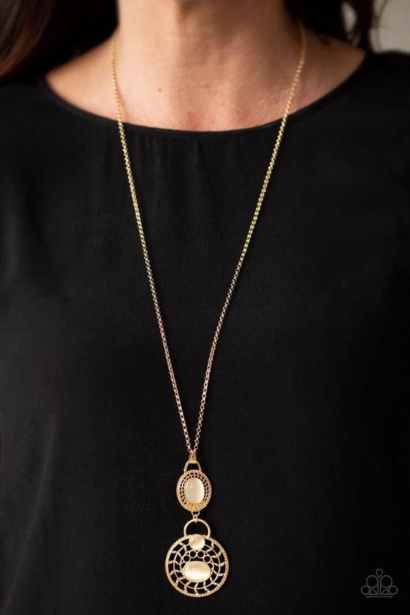 Paparazzi Accessories Hook, Vine, and Sinker - Gold Dotted with glowing cat's eye accents, two dizzying gold frames swing at the bottom of a lengthened gold chain. The stacked pendants swirl with studded patterns and vine-like filigree for a seasonal flai
