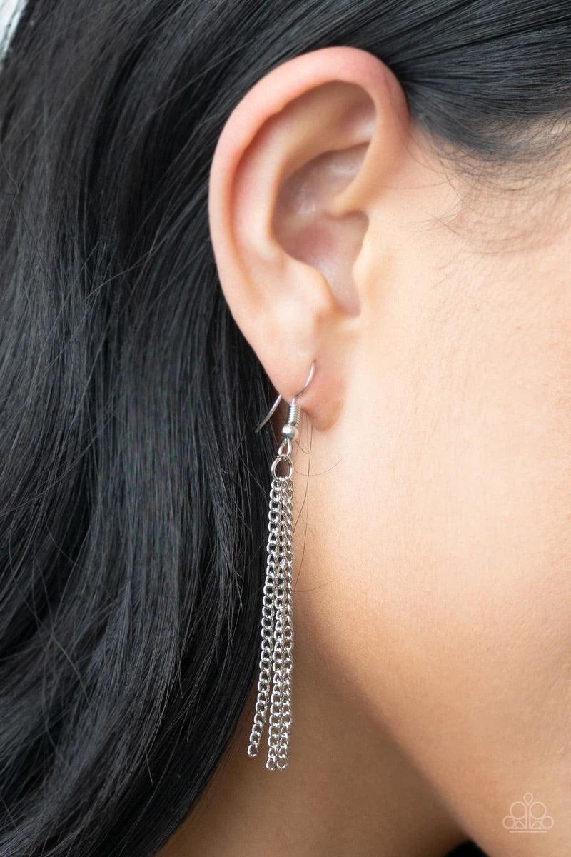 Paparazzi Accessories Blissed Out Opulence - Red An impressive red emerald cut gem is pressed into the center of a silver studded frame, creating an ethereal pop of color at the bottom of a lengthened silver chain. A silver chain tassel swings from the bo