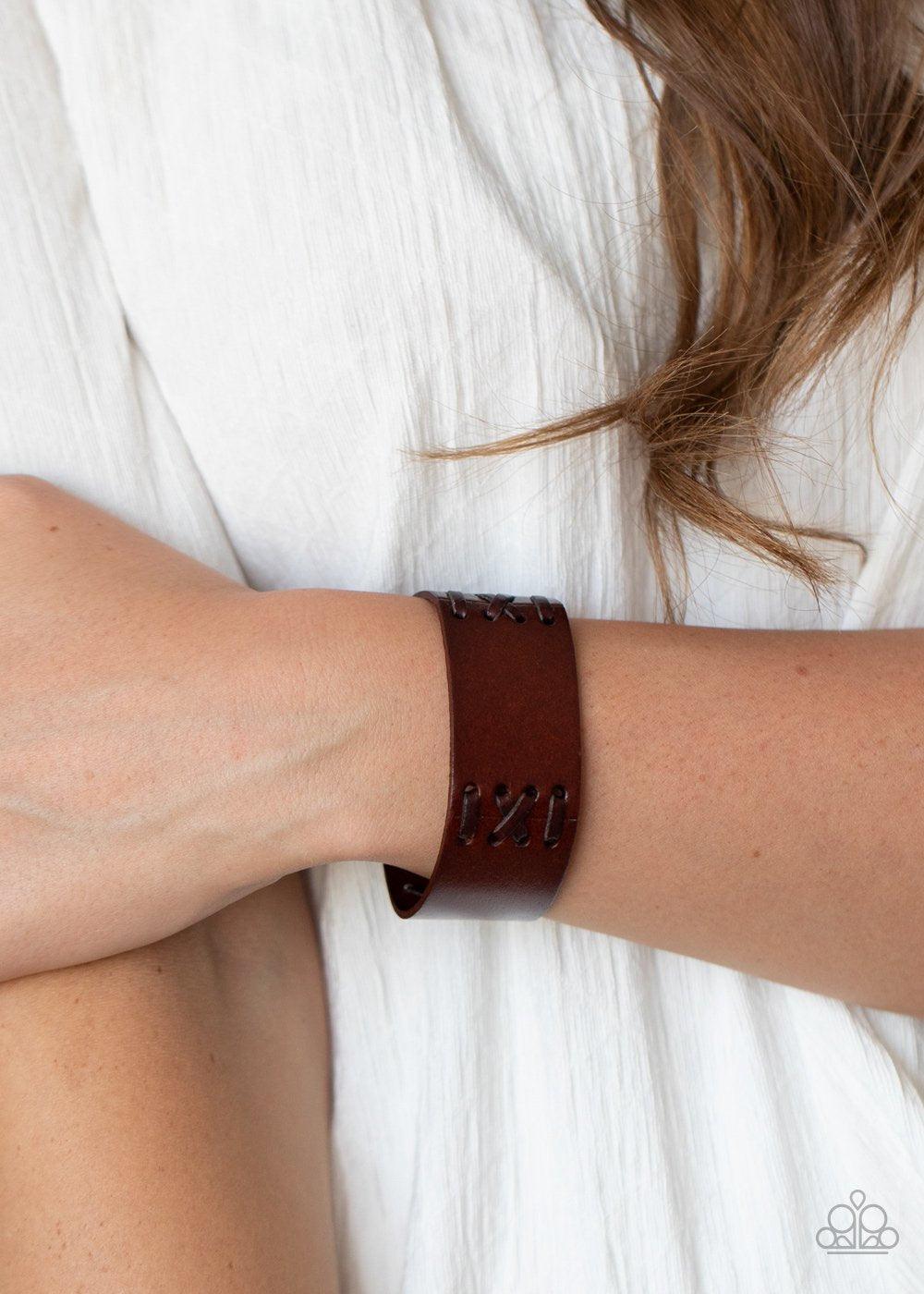 Paparazzi Accessories Batters Up - Brown Sections of leather cording are stitched through a thick brown leather band, creating a rustic look around the wrist. Features an adjustable snap closure. Sold as one individual bracelet. Jewelry