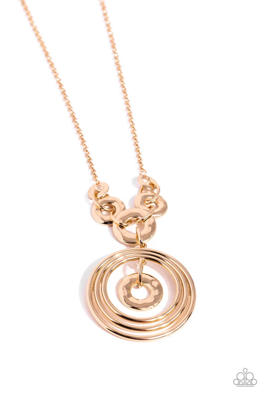 Paparazzi Accessories High Hoops - Gold A trio of high-sheen gold rings swings from the bottom of a collection of hammered, gold hoops connected to an elongated chain in the same hue, creating an asymmetrically stacked pendant. A hammered gold ring swings
