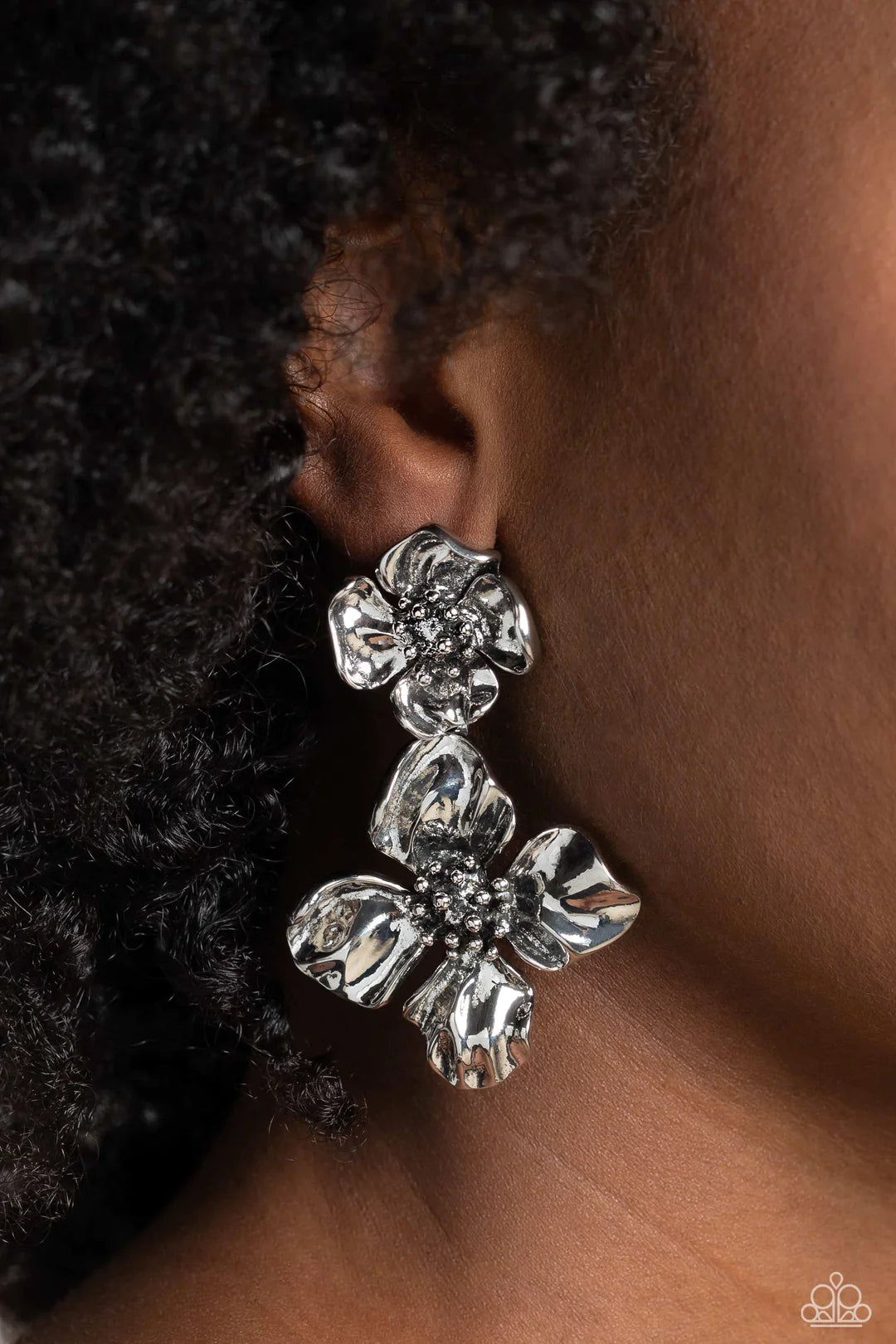 Paparazzi Accessories Gilded Grace - Silver Featuring a warped metallic texture, an oversized silver flower hangs from a smaller silver flower for a whimsical finish. Dainty silver studs coalesce the centers of each flower, adding tactile detail to the fl