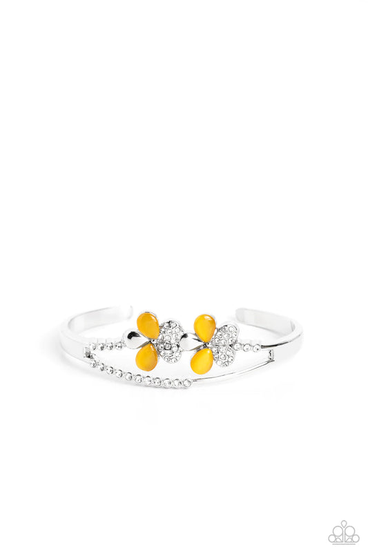 Paparazzi Accessories Broadway Stage - Yellow Splitting off from a high-sheen silver cuff, silver scalloped fittings featuring tiny white rhinestones create an airy opening at the center of the wrist. Infused along the uppermost scalloped fitting, two sid