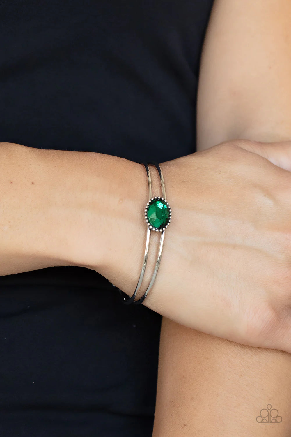 Paparazzi Accessories Magnificently Mesmerized - Green Encased in a studded silver frame, a glittery green gem sits atop a layered silver cuff, creating a mesmerizing centerpiece around the wrist. Sold as one individual bracelet. Jewelry