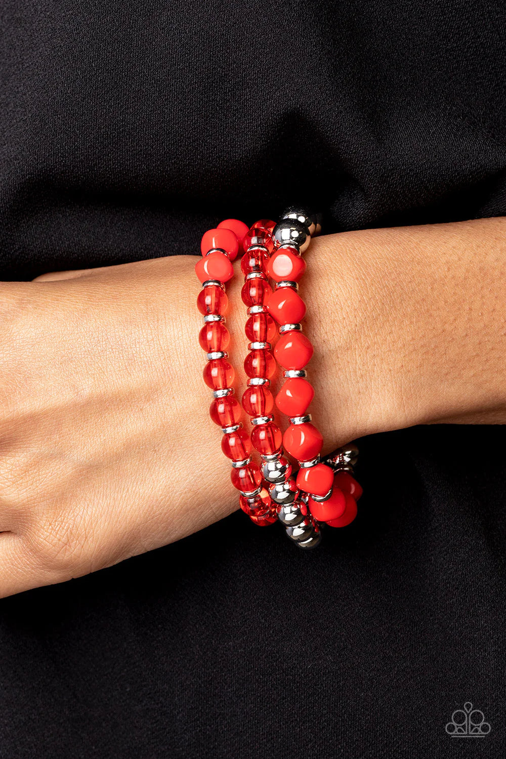 Paparazzi Accessories Summer Sabbatical - Red A mismatched assortment of silver beads, glassy Poinciana beads, dainty silver accents, and faceted Poinciana beads are threaded along stretchy bands around the wrist, resulting in vivacious layers. Sold as on