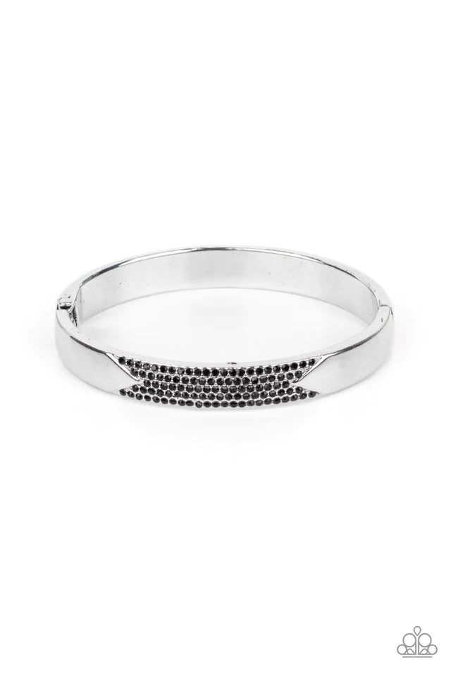 Paparazzi Accessories Radiant Edge - Black Rows of glittery black rhinestones stack horizontally across the center of a silver bangle-like bracelet, creating a sparkly geometric accent around the wrist. Features a hinged closure. Jewelry