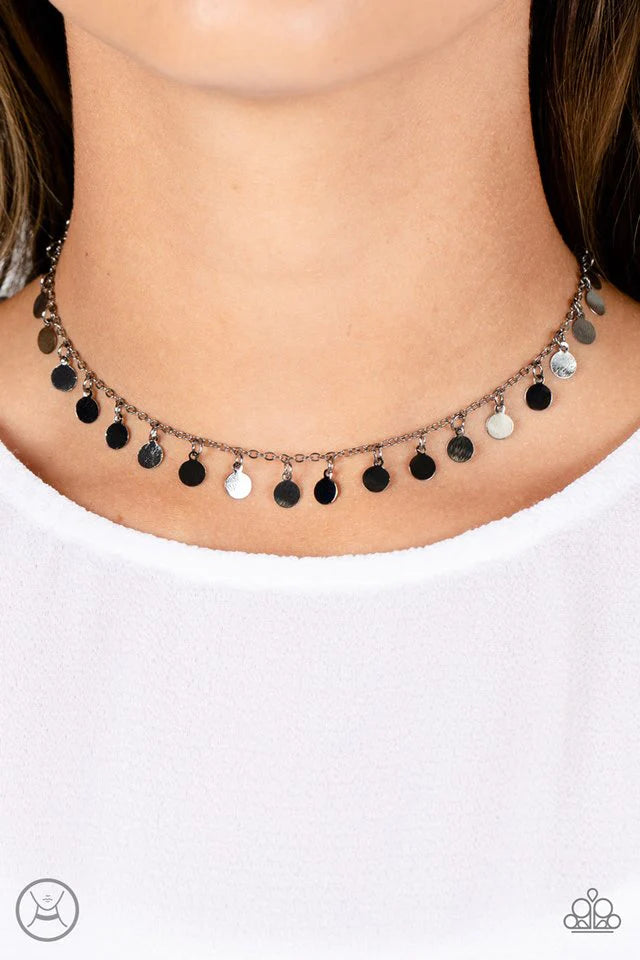 Paparazzi Accessories Champagne Catwalk - Black Tiny gunmetal discs dance along a classic gunmetal chain, creating an understated choker necklace. The reflective surfaces of the discs shimmer brightly, as the light catches their high sheen finish to exagg