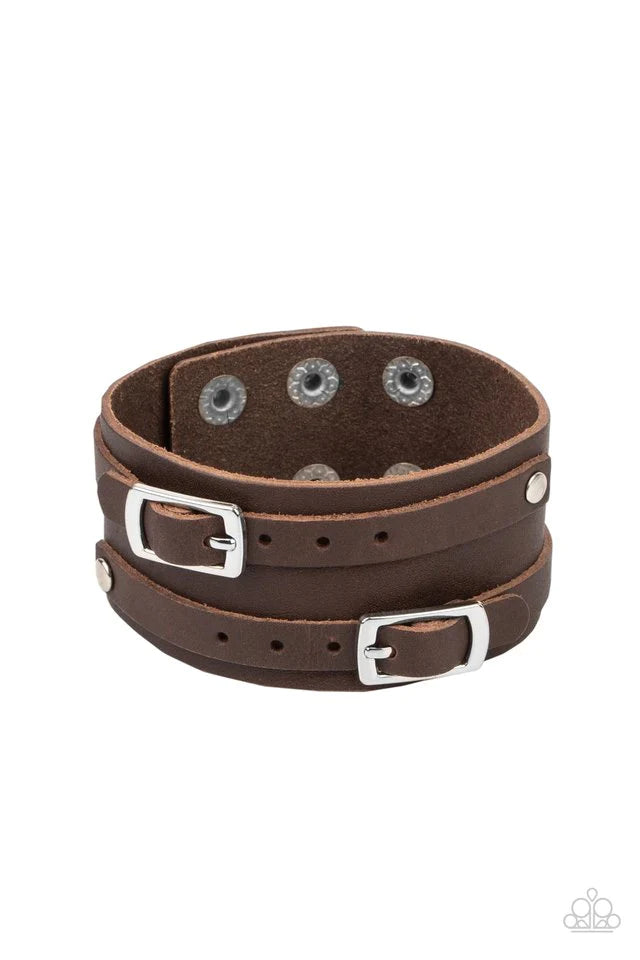 Paparazzi Accessories Bronco Bustin’ Buckles - Brown A pair of brown leather buckles are buckled in place across the front of a rustic brown leather band for a seasonal look. Features an adjustable snap closure Jewelry
