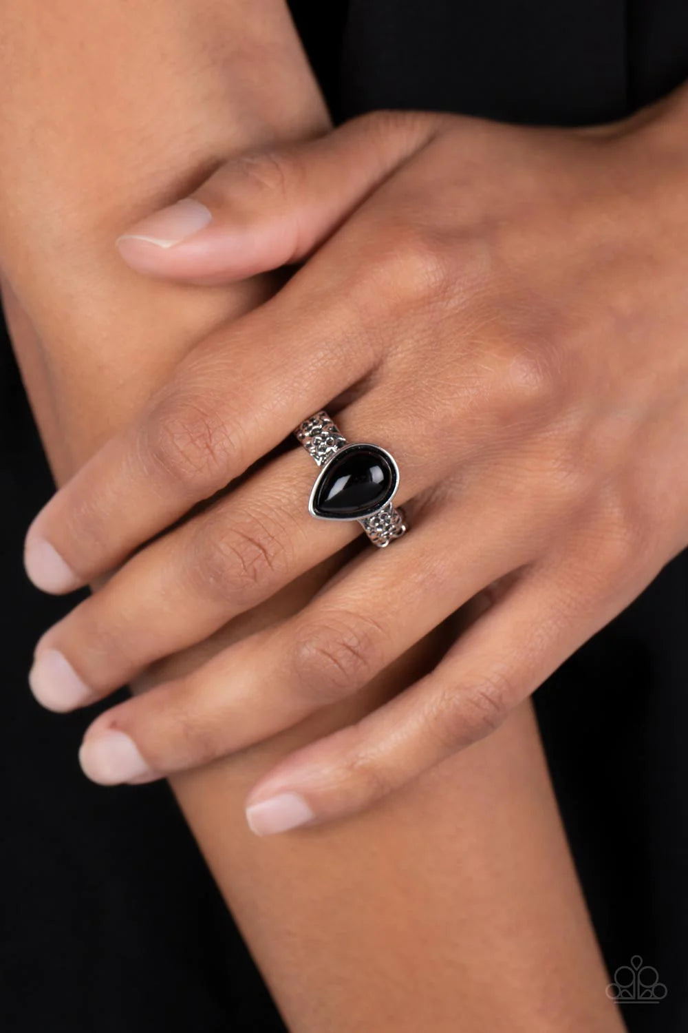 Paparazzi Accessories Rainbow Raindrops - Black A polished teardrop-shaped bead in a black shade is wrapped in a silver frame and set atop a silver band. Floral details embellish the band on each side of the centerpiece, adding a touch of charm as it wrap