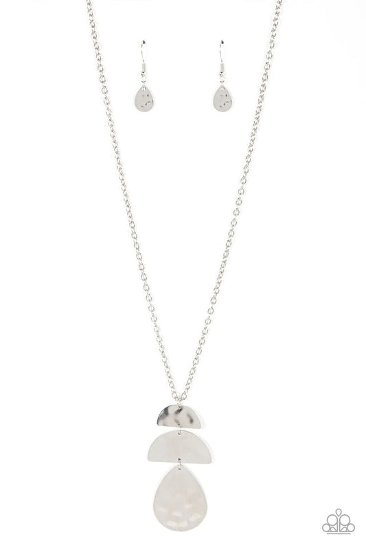 Paparazzi Accessories Mayan Mystery - Silver Brushed in a burnished shimmer, a hammered silver teardrop swings from the bottom of a pair of half moon silver frames that stack into a tribal inspired pendant at the bottom of a classic silver chain. Features