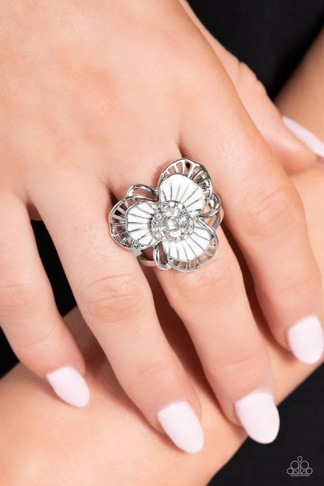 Paparazzi Accessories Tropical Trillium - White A white-petaled flower is layered with sleek, airy silver petals to create a dramatic centerpiece atop the finger. A silver rose bordered by a ring of iridescent rhinestones centers the design while adding u