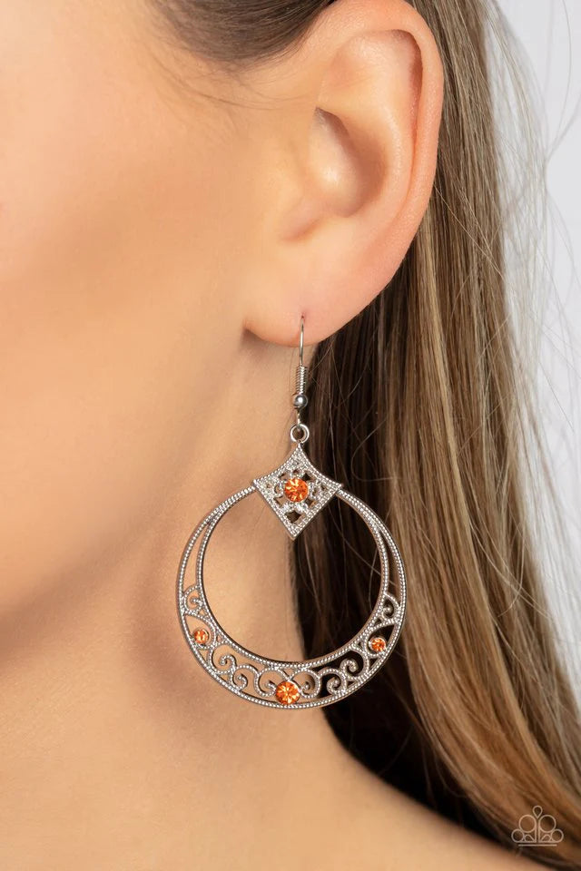 Paparazzi Accessories Royal Resort - Orange Studded silver filigree swirls inside the bottom of a shiny silver hoop that is crowned in a diamond-shaped frame. Glittery orange rhinestones are sprinkled along the vine-like motifs, adding a glitzy finish to