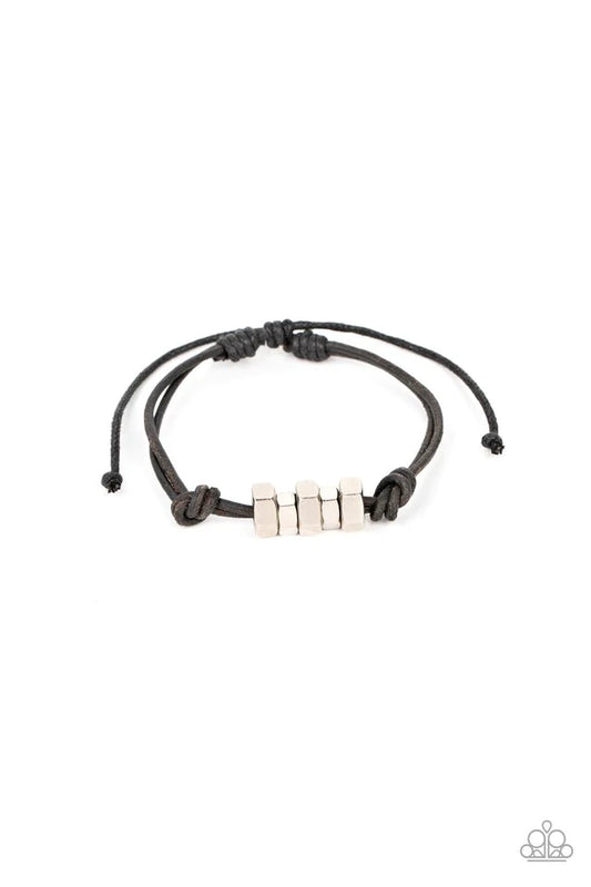 Paparazzi Accessories Bolt Out - Black A row of silver hexagonal hardware is knotted in place along black suede cording around the wrist, creating an edgy urban look. Features an adjustable sliding knot closure. Jewelry