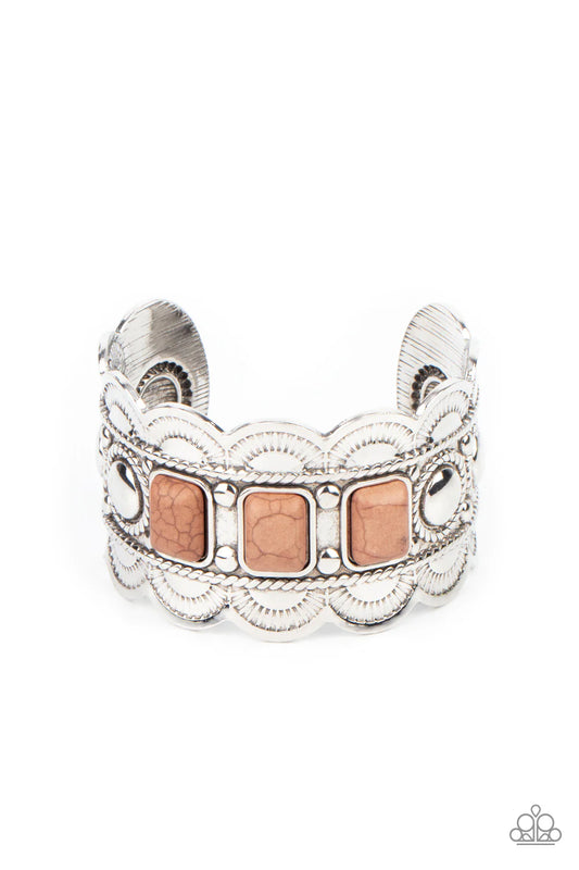 Paparazzi Accessories Rio Rancho Retreat - Brown A trio of rectangular brown stones are pressed into the center of a scalloped silver cuff that is stamped and embossed in rustic details, creating an earthy centerpiece around the wrist. Sold as one individ