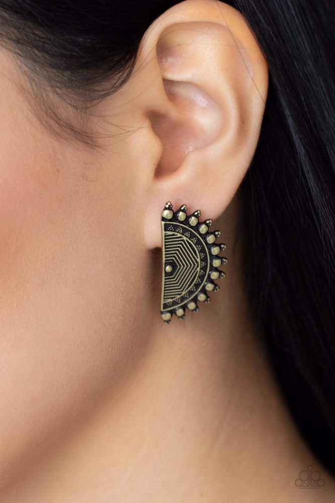 Paparazzi Accessories Fiercely Fanned Out - Brass Tipped with triangular accents, flat brass studs fan out from the edge of a half moon frame embossed in antiqued linear texture, creating a bold tribal inspired display. Earring attaches to a standard post