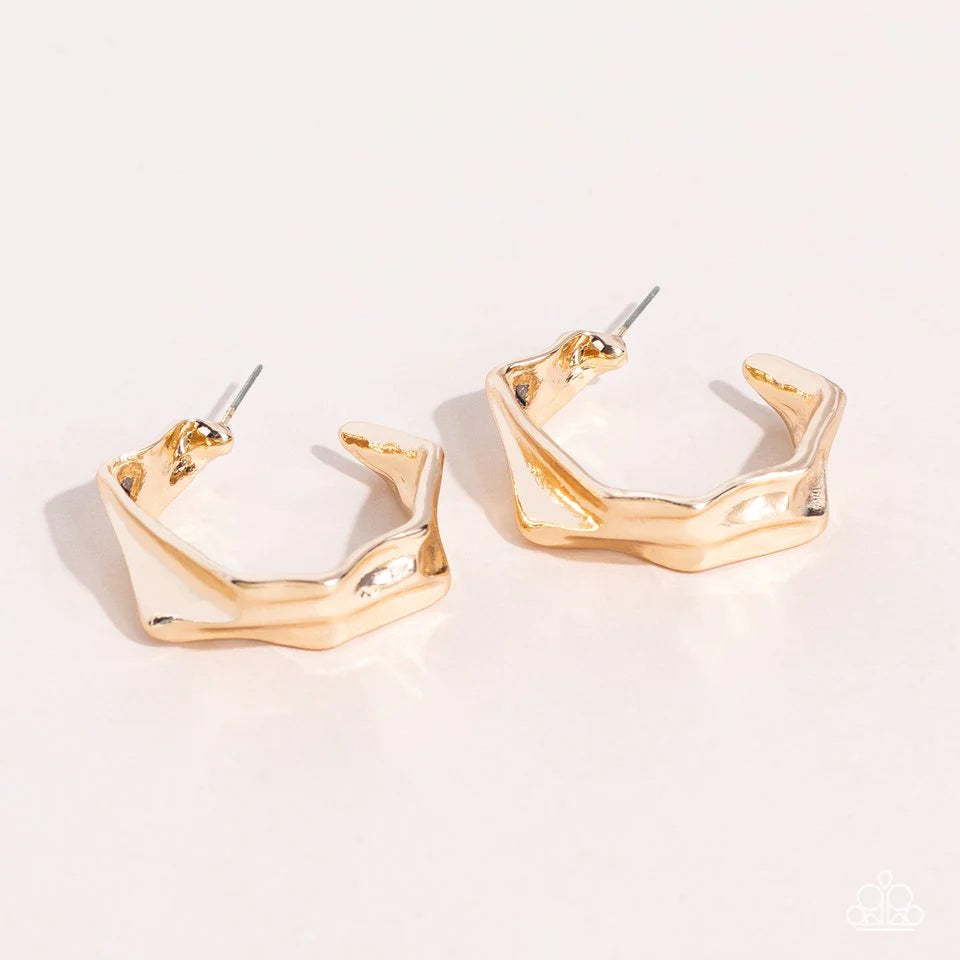Paparazzi Accessories Cutting Edge Couture - Gold Featuring faceted edges, a warped gold frame curves into an asymmetrical hoop for an intense industrial flair. Earring attaches to a standard post fitting. Hoop measures approximately 1 1/4" in diameter Je