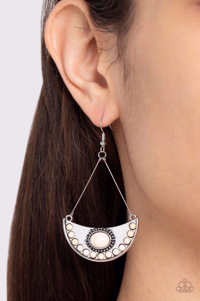 Paparazzi Accessories Canyon Canoe Ride - White Suspended from wire fittings, a silver half moon frame is dotted in refreshing white stone accents as it swings from the ear for an artisan inspired look. Earring attaches to a standard fishhook fitting. Sol