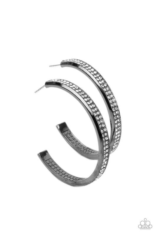 Paparazzi Accessories Flash Freeze - Black Two rows of glitzy white rhinestones are encrusted along the outside curve of a gritty gunmetal hoop, creating an understated rocker look. Earring attaches to a standard post fitting. Hoop measures approximately