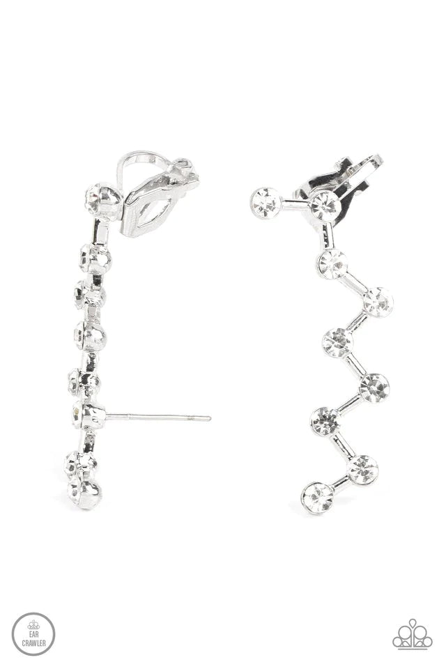 Paparazzi Accessories Clamoring Constellations - White Strategically placed white rhinestones are connected by dainty silver bars as they zigzag up the ear, creating a stellar constellation. Earring attaches to a standard post fitting. Features a dainty c