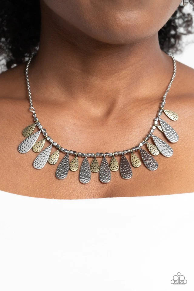 Paparazzi Accessories Compelling Confetti - Multi Streaming from a collection of abstract silver studs, brass and silver, metallic teardrops in varying sizes curve up towards the neckline. Featuring a hammered dot motif, the boisterous collection of studs
