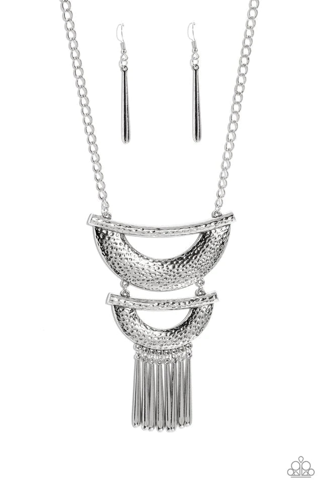 Paparazzi Accessories Fringe Festival - Silver Hammered in textured detail, two oversized silver half moon plates connect down the chest, creating a fiercely stacked pendant. Sleek silver rods swing from the bottom of the lowermost plate, creating an eye-