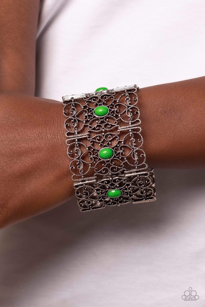 Paparazzi Accessories Fairest Filigree - Green Shiny green beads, set in vertical, rectangular frames of swirling silver filigree are infused along stretchy bands for a whimsically wild fashion around the wrist. Sold as one individual bracelet. Jewelry