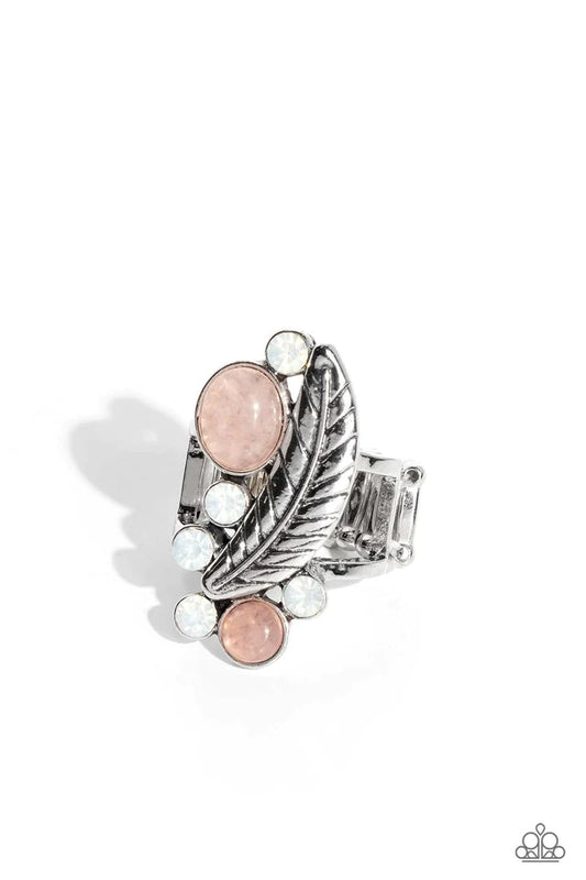 Paparazzi Accessories Off To FEATHER-land - Pink Opalescent white rhinestones and rose quartz stones in oval and round cuts haphazardly adorn the front of an airy silver frame. An intricate-detailed silver feather curves up and around the earthy and stony