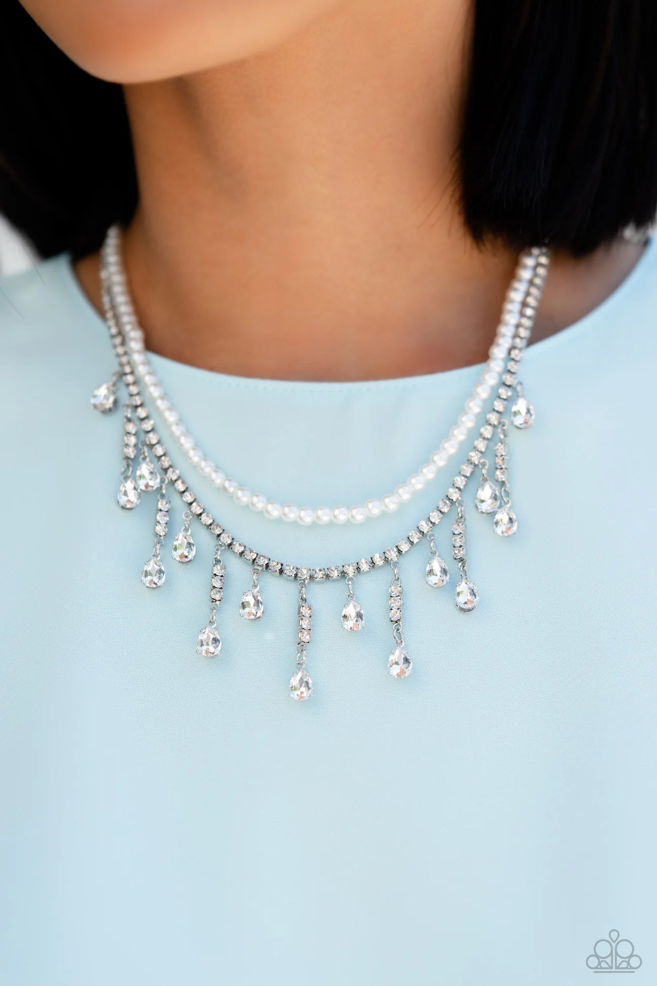 Paparazzi Accessories Lessons in Luxury - White Featuring a white rhinestone square-fitting chain, white teardrop-cut gems, bordered in silver pronged fittings, swing from streams of glittery rhinestones while solitaire teardrop gems drip in an alternatin