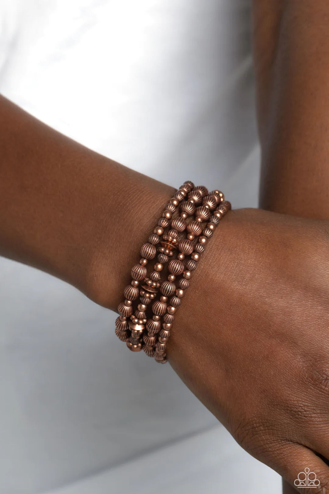 Paparazzi Accessories Striped Stack - Copper Coiling around the wrist, striped copper beads of varying sizes, interacts with copper accents, copper wheel beads, and copper discs for an eye-catching, endless, monochromatic design. Sold as one individual br