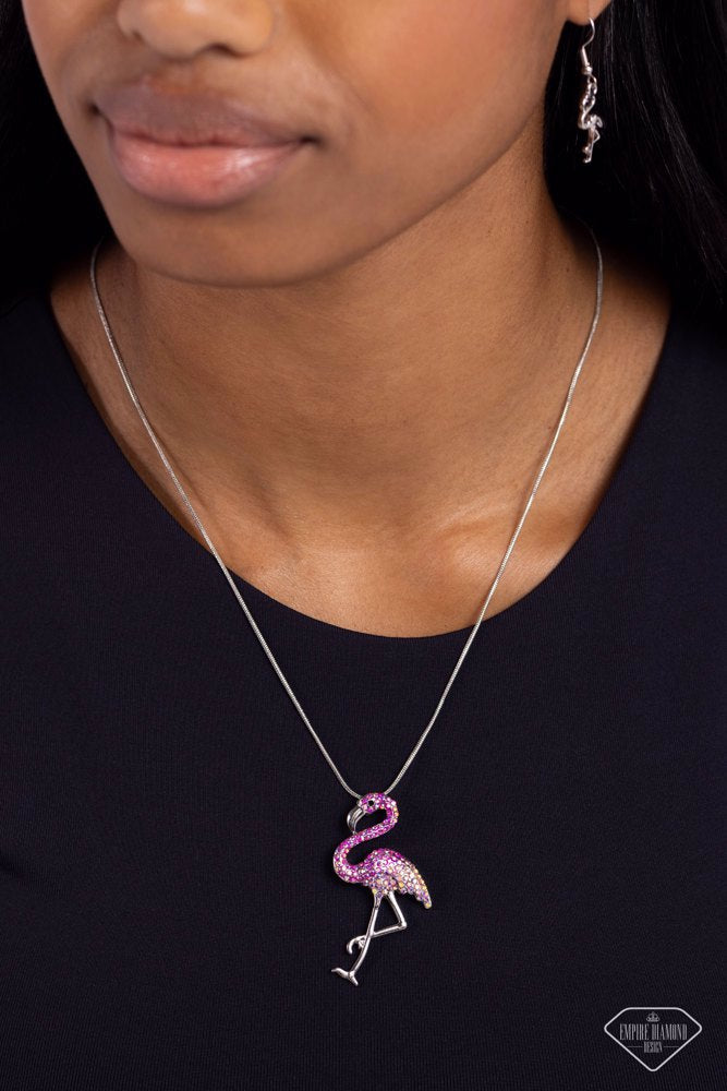 Paparazzi Accessories Flamingo Finesse - Pink Featuring an ombré effect of fuchsia iridescent rhinestones to light pink iridescent rhinestones, a flamingo charm with a silver beak, silver legs, and a black beaded eye, glides along a sleek silver snake cha