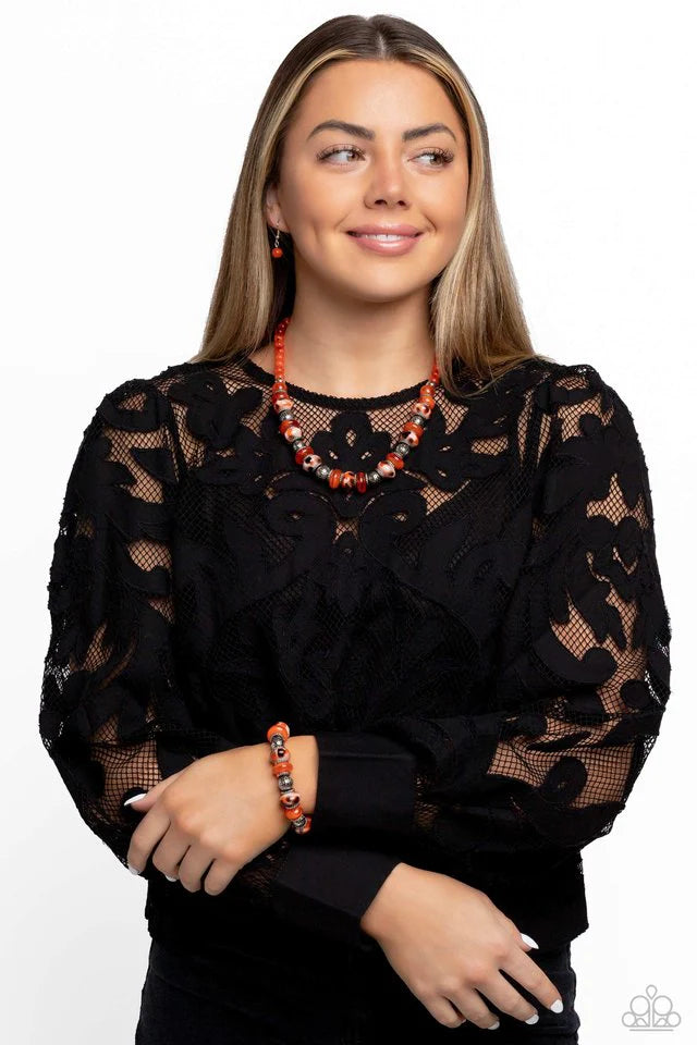 Paparazzi Accessories Warped Wayfarer - Orange An earthy collection of dotted silver beads, rounded milky orange beads, studded silver rings, orange-spotted ceramic-like beads and textured silver beads are threaded along an elastic stretchy band around th