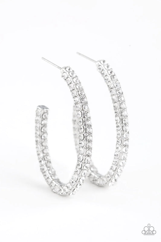 Paparazzi Accessories Big Winner - White Glassy white rhinestones are encrusted along three sides of an abstract silver hoop for a glamorous look. Earring attaches to a standard post fitting. Hoop measures 1" in diameter. Sold as one pair of hoop earrings