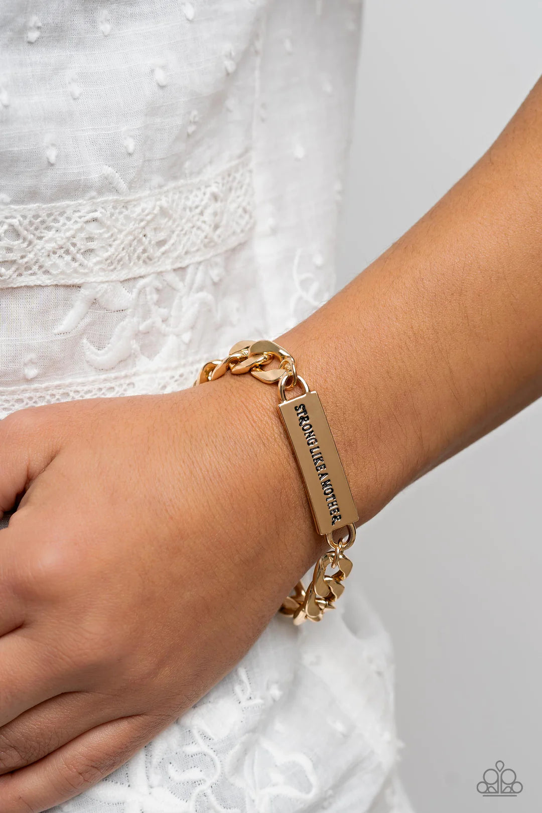 Paparazzi Accessories Mighty Matriarch - Gold Attached to a thick, gold curb chain, a rectangular plate is stamped with the phrase "strong like a mother," for a sentimental, urban statement around the wrist. Features an adjustable clasp closure. Sold as o
