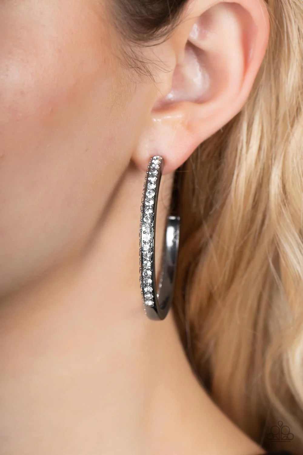 Paparazzi Accessories Powerhouse Precision - Black The front and outer edge of a timeless gunmetal hoop is unexpectedly encrusted in glassy white rhinestones, adding a timeless twist to the powerhouse piece. Hoop measures approximately 2" in diameter. Ear