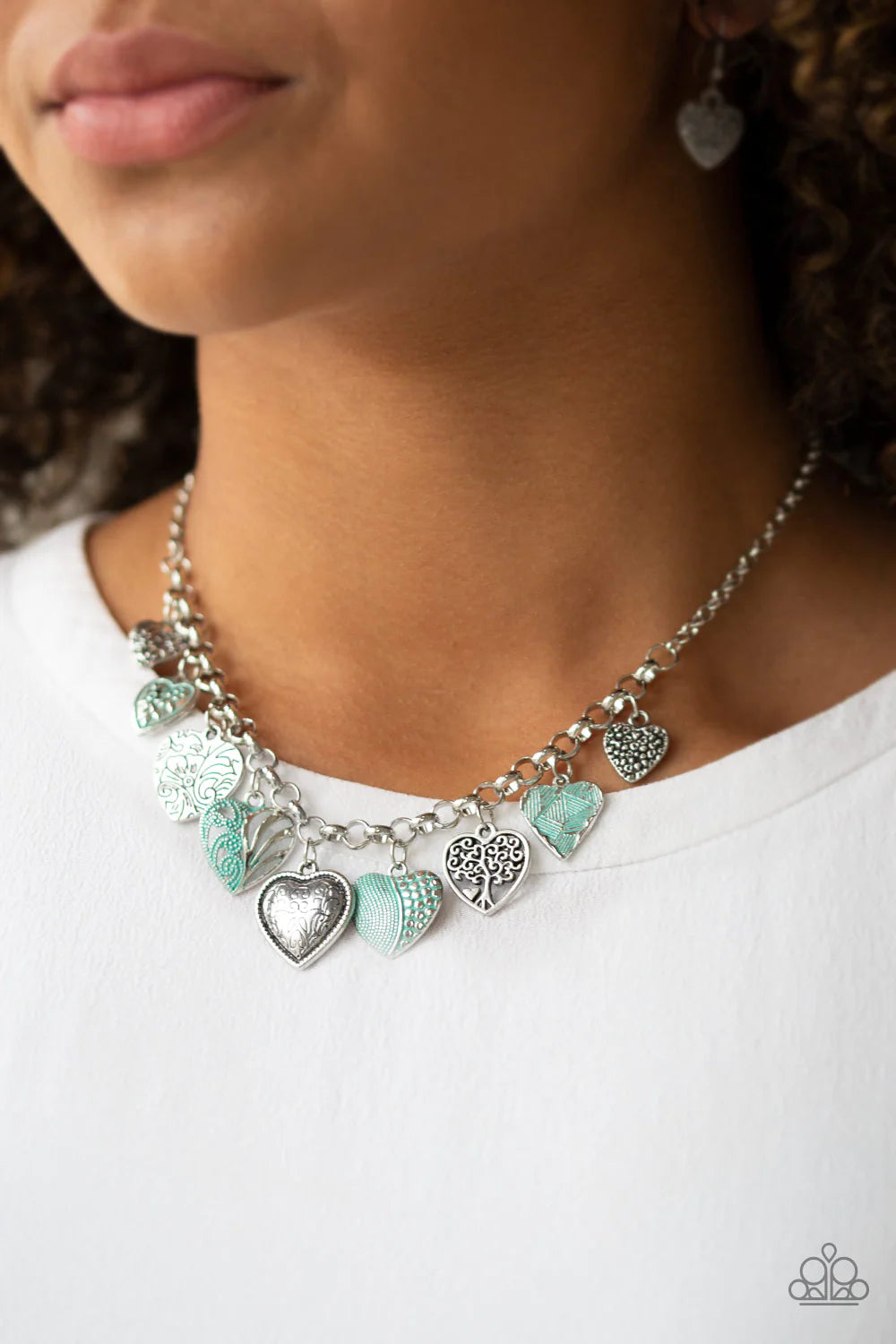 Paparazzi Accessories Grow Love - Green Featuring an array of floral patterns, a collection of silver hearts swings from the bottom of a shimmery silver chain. Alternating charms are brushed in a minty green finish, creating a colorful fringe below the co