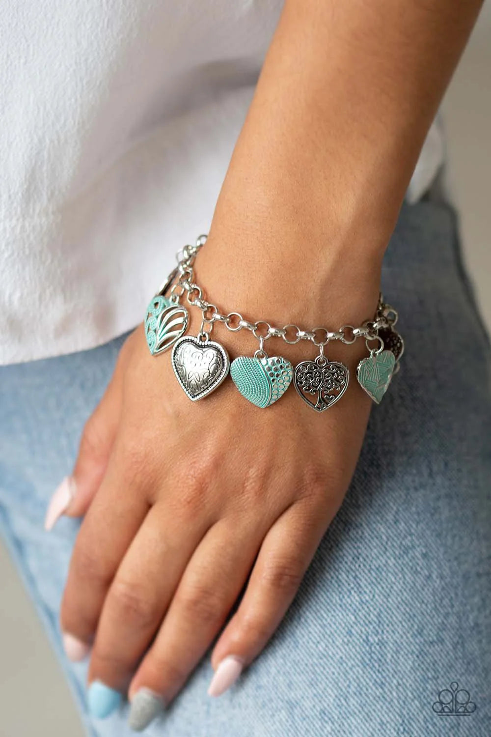 Paparazzi Accessories Garden Hearts - Green Featuring an array of floral patterns, a collection of silver hearts swings from a shimmery silver chain. Alternating charms are brushed in a minty green finish, creating a colorful fringe around the wrist. Feat