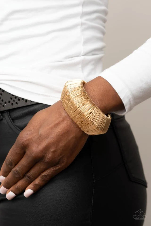 Paparazzi Accessories Wild About Wire - Gold Layer after layer of glistening gold wire wraps around an oversized gold cuff. The center of the wire wrap comes to a peak, adding edge to the intense industrial display. Jewelry