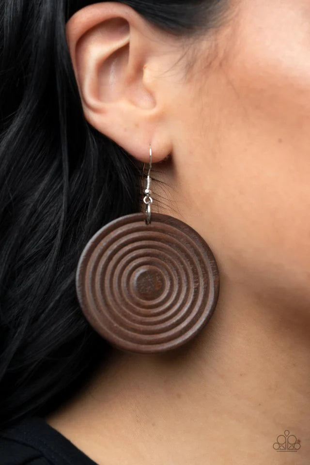 Paparazzi Accessories Caribbean Cymbal - Brown A shiny brown wooden disc is engraved in circular details, resulting in a dizzying pop of color. Earring attaches to a standard fishhook earring. Jewelry
