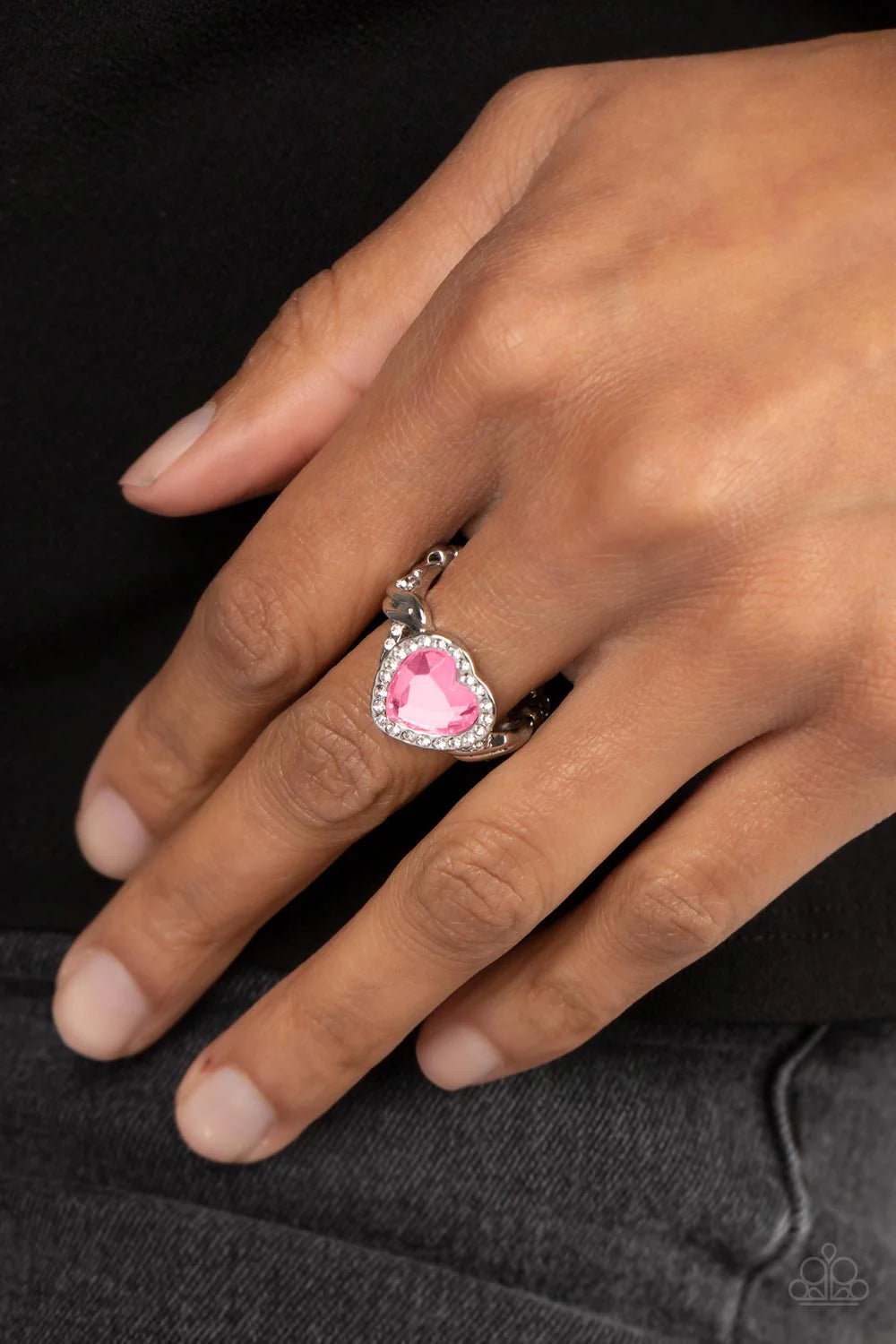 Paparazzi Accessories Committed to Cupid - Pink A faceted pink heart gem is pressed into a silver heart frame studded with dainty white crystals for a romantic centerpiece atop the finger. Textured twists dotted with similar dainty crystals climb up the s