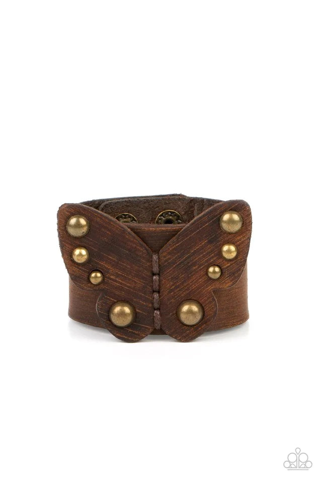 Paparazzi Accessories Butterfly Farm - Brass Dotted with antiqued brass studs, a distressed leather butterfly is studded in place across the center of a distressed brown leather band for a rustic flair. Features an adjustable snap closure. Jewelry