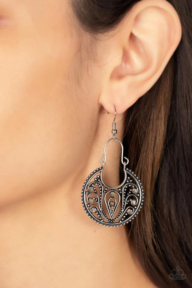 Paparazzi Accessories Vineyard Villa - Brown Dotted with golden topaz rhinestones, a studded crescent shaped frame is filled with vine-like filigree as it swings from a dainty silver wire fitting for a whimsical flair. Earring attaches to a standard fishh