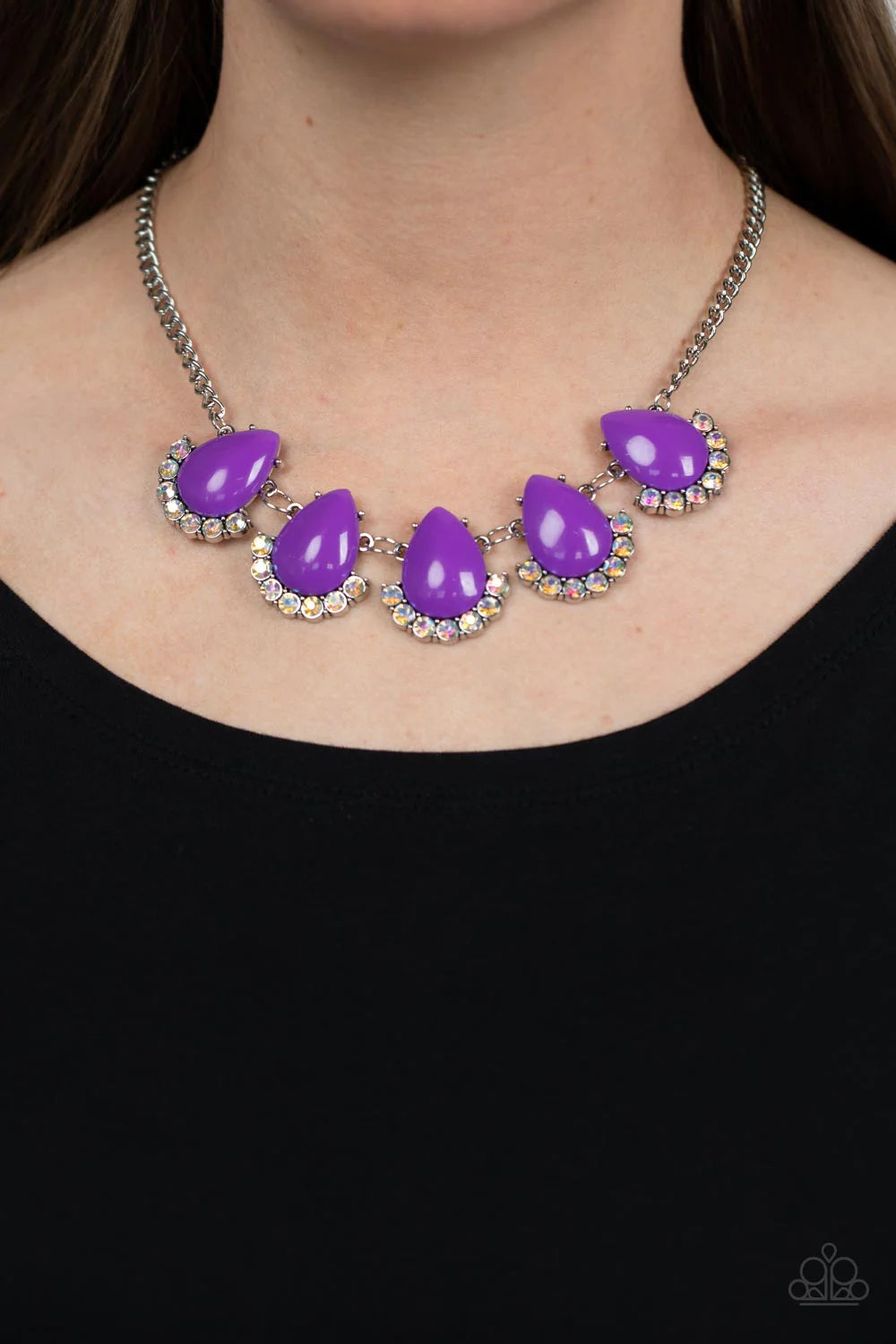 Paparazzi Accessories Ethereal Exaggeration Underscored by rows of iridescent rhinestones, a row of oversized purple teardrop beads dramatically links into a powerful pop of color below the collar. Features an adjustable clasp closure. Due to its prismati