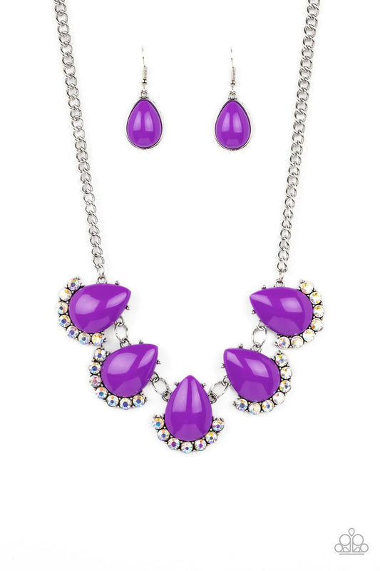 Paparazzi Accessories Ethereal Exaggeration Underscored by rows of iridescent rhinestones, a row of oversized purple teardrop beads dramatically links into a powerful pop of color below the collar. Features an adjustable clasp closure. Due to its prismati