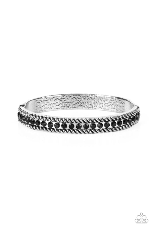 Paparazzi Accessories Rebel Renaissance - Black Gritty silver rope-like borders flank a glitzy row of black rhinestones, creating a smoldering bangle-like bracelet around the wrist. Features a hinged closure. Sold as one individual bracelet. Jewelry